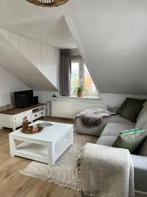 a living room with a couch and a table at ZilverMoon in Egmond aan Zee