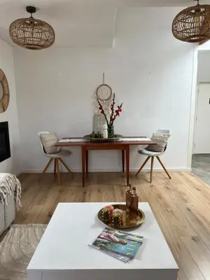 a living room with a table and chairs at ZilverMoon in Egmond aan Zee