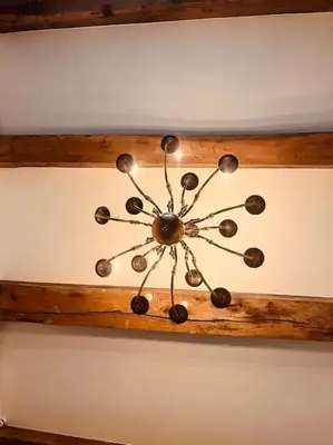 a chandelier hanging from the ceiling of a room at Historisch grachtenpand in centrum Gouda in Gouda