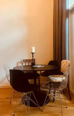 a dining room table with chairs and a lamp on it at Historisch grachtenpand in centrum Gouda in Gouda