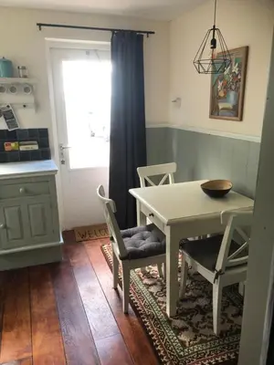 a kitchen with a table and chairs and a window at Appartement in schuur in Twisk