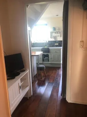 a small kitchen with a table and a television at Appartement in schuur in Twisk