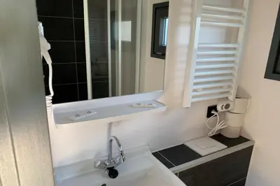 a white bathroom with a sink and a mirror at Heerlijke Houseboat 