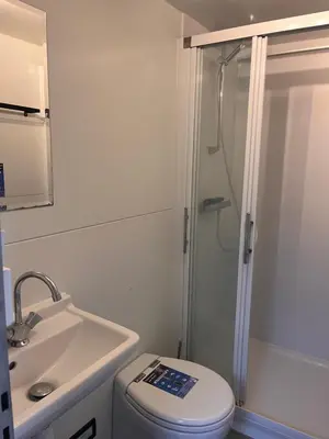 a bathroom with a shower and a toilet and a sink at Houseboat Oslo perfect voor bezoek Amsterdam in Monnickendam