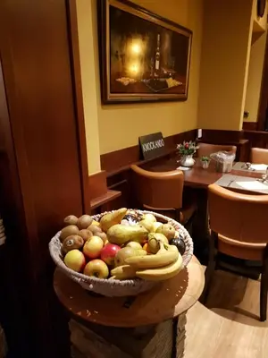 a bowl of fruit on a table in a restaurant at Hotel Zee en Duin in Katwijk