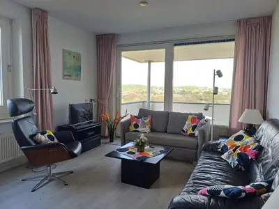 a living room with a couch and a table at JulianaDuin in Bergen aan Zee