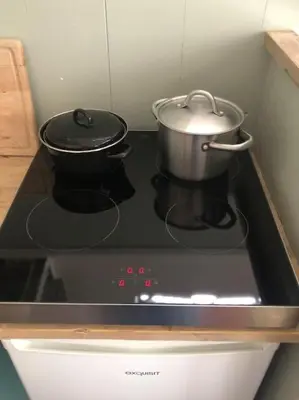 two pots and pans on a stove in a kitchen at Appartement voor twee personen in Twisk