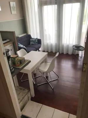 a living room with a white table and chairs at Appartement voor twee personen in Twisk