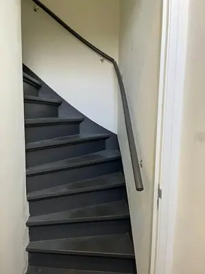 a staircase with black steps in a room at Stadscentrum, rustige toplocatie! in Amersfoort