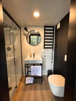 a bathroom with a toilet and a sink and a shower at Amsterdam Beach House in Zandvoort
