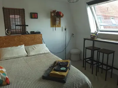 a bedroom with a bed with a tray on it at Kraaipan B&B in Amsterdam