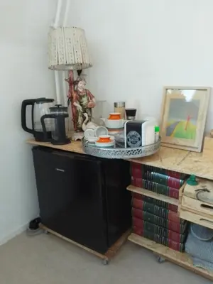 a kitchen counter with a table with a lamp on it at Kraaipan B&B in Amsterdam