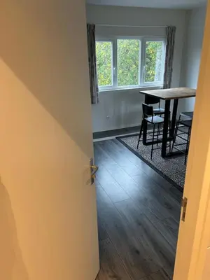 an open door to a dining room with a table at Private Apt Amsterdam in Amsterdam