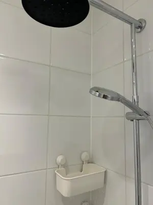a white bathroom with a sink and a shower at Private Apt Amsterdam in Amsterdam