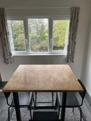a dining room table with two chairs and two windows at Private Apt Amsterdam in Amsterdam