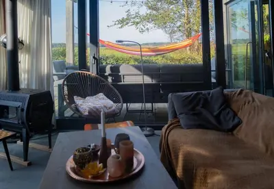 a living room with a couch and a table at Dunes of Egmond in Egmond-Binnen