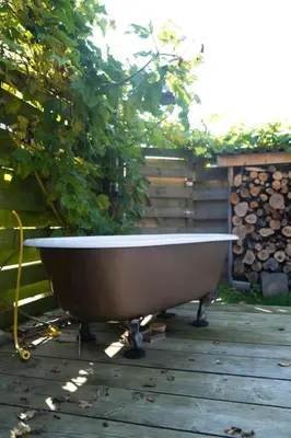 a bath tub sitting on a wooden deck at Dunes of Egmond in Egmond-Binnen