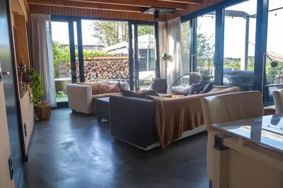 a living room with a couch and a table at Dunes of Egmond in Egmond-Binnen