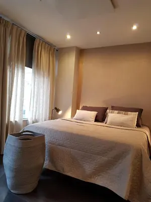 a bedroom with a large bed and a window at The Fabulous Suite in Amsterdam