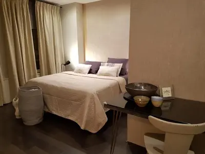 a bedroom with a bed and a table with a bowl on it at The Fabulous Suite in Amsterdam