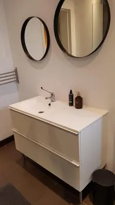 a bathroom with a white sink and a mirror at The Fabulous Suite in Amsterdam
