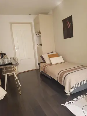 a bedroom with two beds and a table and a door at The Fabulous Suite in Amsterdam
