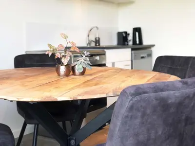 a wooden table with potted plants on it in a kitchen at Guesthouse ML in Hillegom