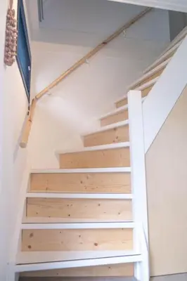 a staircase in a house with wooden risers at Duinhuis Zout Hout in Egmond-Binnen