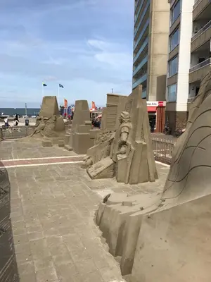 a sand sculpture of a letter m on a beach at Berrie's Sea View in Zandvoort