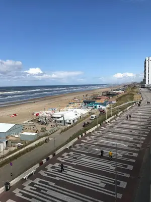 a large parking lot next to a beach at Berrie's Sea View in Zandvoort