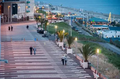 a group of people walking down a stairs near the beach at Berrie's Sea View in Zandvoort