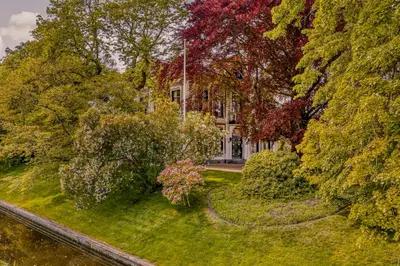 an aerial view of a house surrounded by trees at Villa Abbekerk - Bed & Breakfast in Abbekerk
