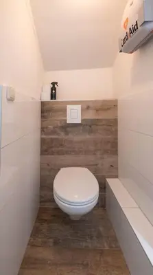 a bathroom with a white toilet in a room at Hosted by wendy Old city charming accommodation in Wassenaar