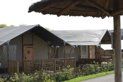 a building with a tent in front of it at Safari Lodges Premium in Nieuwe Wetering