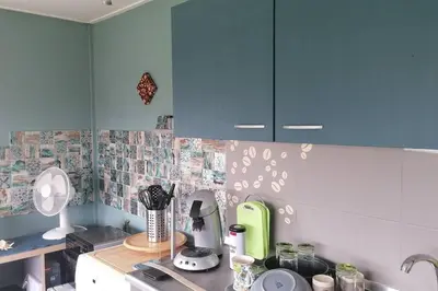 a kitchen with blue cabinets and a counter top at Tinyhouse CARPE DIEM in Dirkshorn