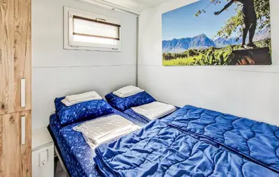 a bedroom with a bed and a painting on the wall at Johannesburg in Naarden