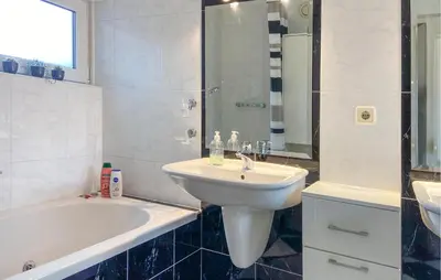 a bathroom with a sink and a shower and a tub and a sink at Pet Friendly Home In Opperdoes in Opperdoes