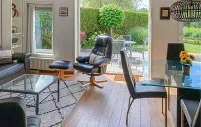 a living room with a chair and a table at Pet Friendly Home In Opperdoes in Opperdoes