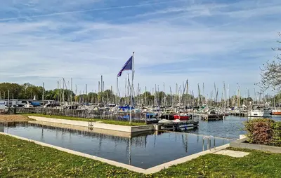 a marina with a blue flag and many boats at Sydney in Naarden