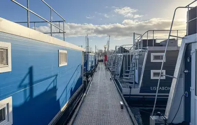 a train station with two trains parked next to each other at Stellenbosch in Naarden