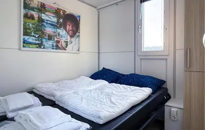 a bed in a room with a picture on the wall at Monaco in Naarden