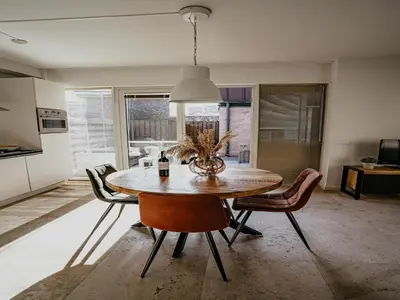 a kitchen and dining room with a table and chairs at Seaside Stay in Egmond in Egmond aan Zee