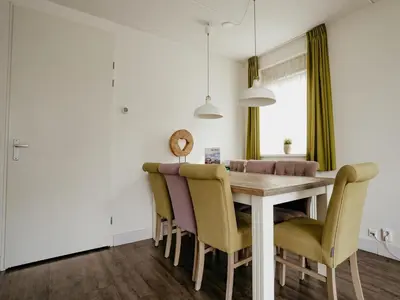 a dining room with a table and chairs at Spacious Lakeside Retreat in Uitgeest