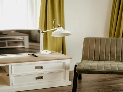 a lamp sitting on a desk next to a chair at Spacious Lakeside Retreat in Uitgeest