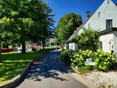 a street in a town with a white building at Park De Driesprong in Nieuwveen