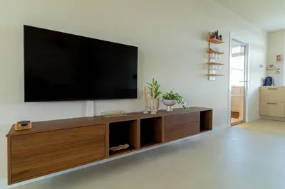 a living room with a flat screen tv on a wall at Casa Buena Vista in Egmond aan Zee