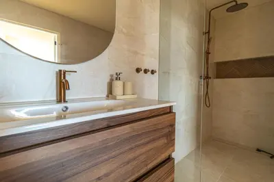 a bathroom with a sink and a shower at Casa Buena Vista in Egmond aan Zee