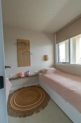 a bedroom with a bed and a large window at Casa Buena Vista in Egmond aan Zee
