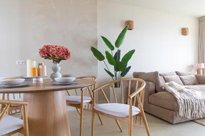 a living room with a table and chairs and a couch at Casa Buena Vista in Egmond aan Zee