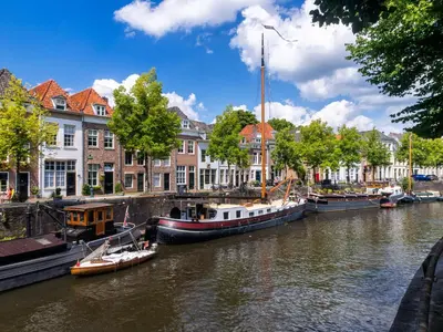 a group of boats are docked on a river at Terraced Bedroom in Utrecht